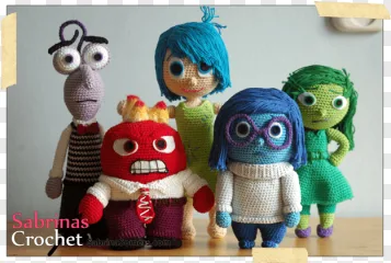 A group of colorful handmade crochet monster dolls on a transparent background.