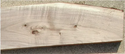 A rustic natural light brown wood board displayed on a transparent background.