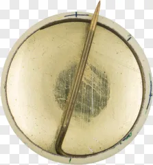 A close-up view of a vintage metallic pin on a transparent background.