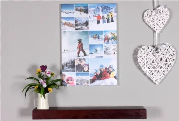 A ski photo collage hanging on a wall above a shelf on a transparent background.