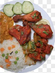 A plate of spicy chicken curry with rice, cucumber, lemon, and peas on a transparent background.